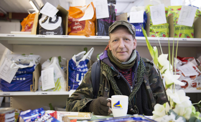 client with cup of tea in foodbank centre