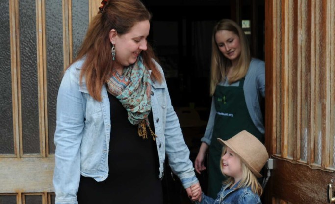 young family at foodbank entrance